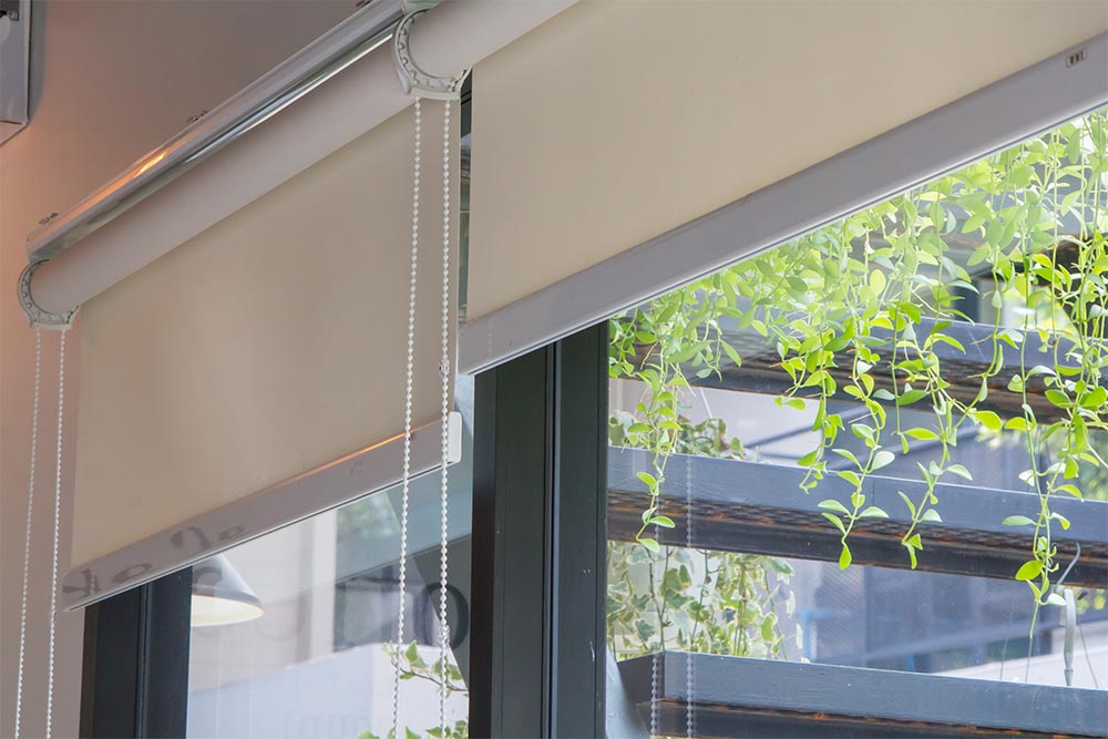 Roller blinds with green window frame - Beautiful Homes