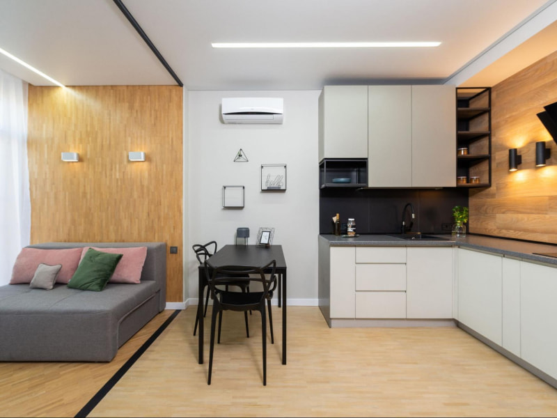 Oriented strand board used as wall décor in this open kitchen dining & bedroom design - Beautiful Homes
