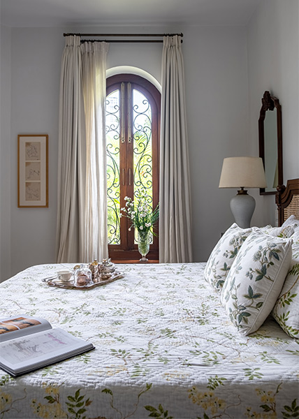 Master bedroom with arched windows & white curtains - Beautiful Homes