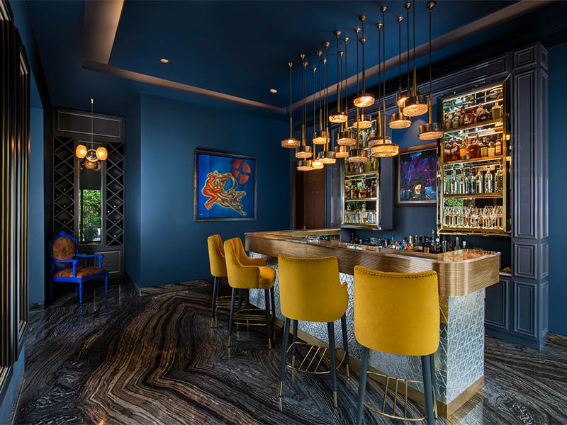 Indian home bar design with yellow chairs & blue walls - Beautiful Homes