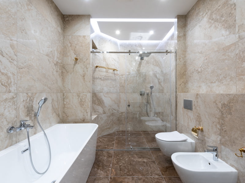 Simple bathroom tiles design with bidet & tub - Beautiful Homes