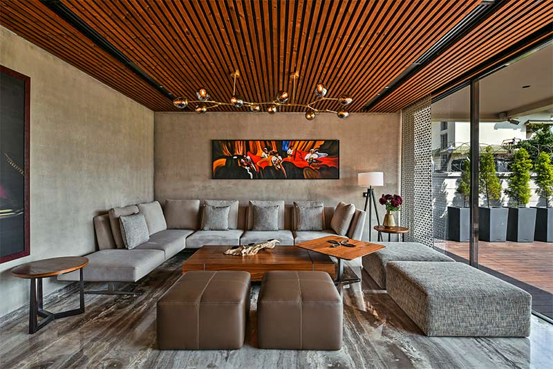 Wooden PVC ceiling design with a chandelier in a luxury living room - Beautiful Homes