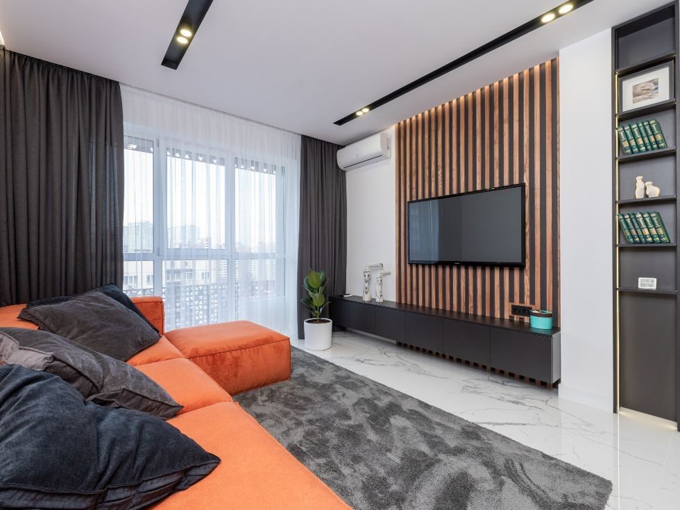 Wooden accented wall behind the TV  - Beautiful Homes