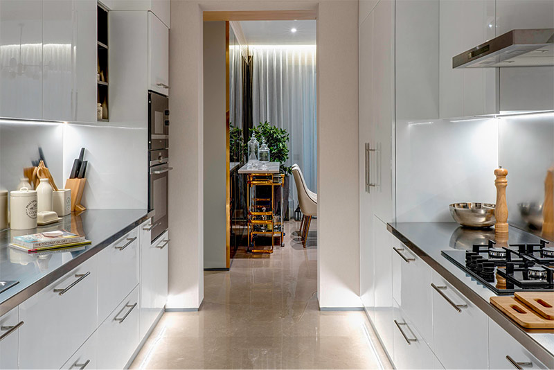 An elegant white modular parallel kitchen design - Beautiful Homes