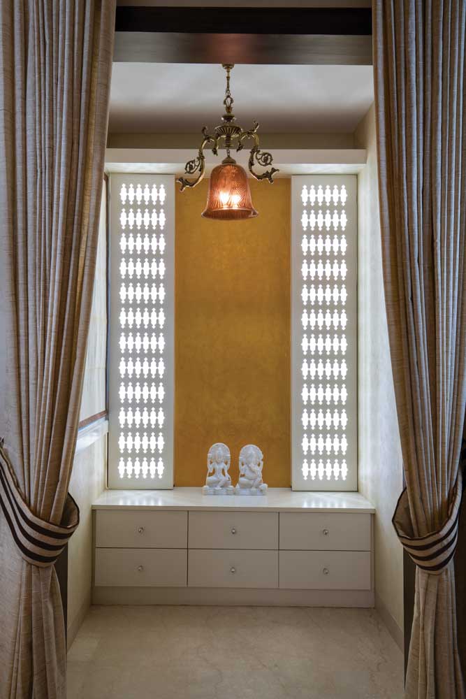 Temple design that is temporarily made in a lobby of the house with curtain dividers - Beautiful Homes