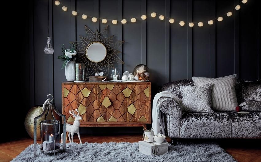 Living room with a grey sofa and grey rug, along with a wooden cabinet