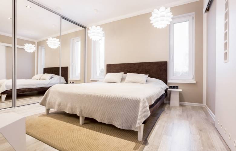 Contemporary sliding wardrobe design with reflective surface - Beautiful Homes