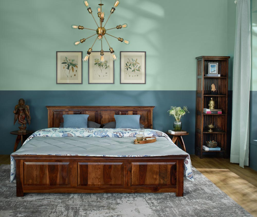 Modern chandelier in bedroom with wooden furniture & rustic rug - Beautiful Homes