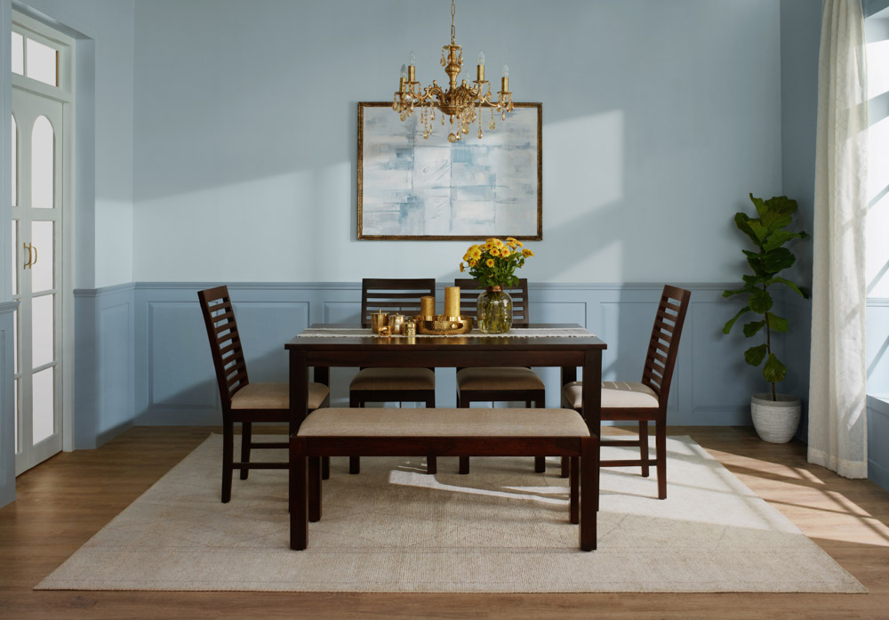 Traditional jhumar in this blue shaded dining room with wooden dining furniture - Beautiful Homes