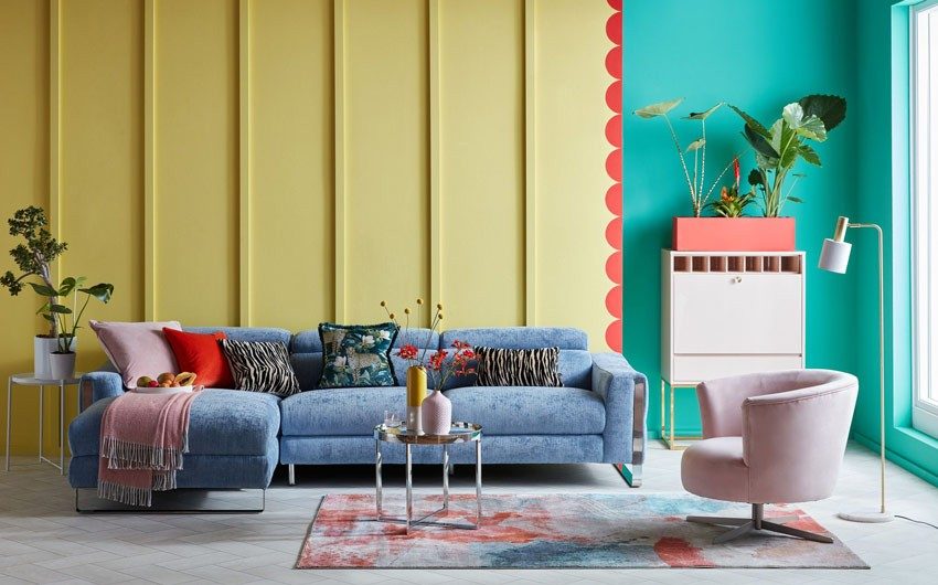 A yellow and green living room with a blue sofa A yellow and green living room with a blue sofa