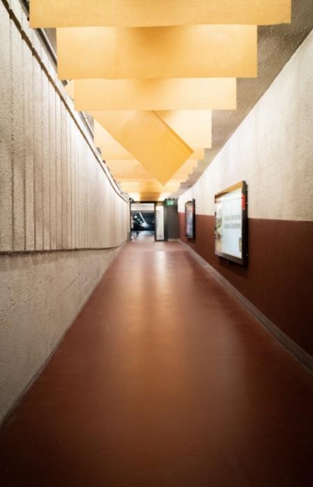 Hallway passage with liquid red oxide flooring - Beautiful Homes