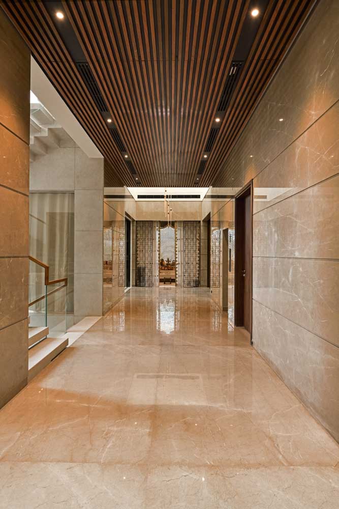 This corridor has a wooden ceiling with visual demarcation with the rest of the home - Beautiful Homes