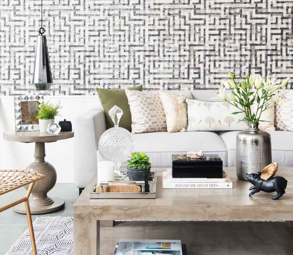 Maze pattern wallpaper matching with rugs and other fabrics of the room - Beautiful Homes Maze pattern wallpaper complementing with other geometrical shaped pattern of the fabrics in the room - Beautiful Homes