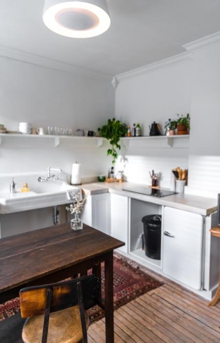 All white L-shape modular kitchen design idea with a breakfast counter - Beautiful Homes
