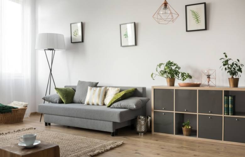 Small cabinet & cane baskets to sneak in storage space in the living room - Beautiful Homes