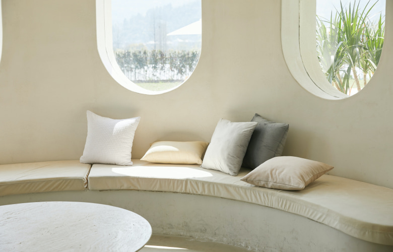 Linen cushion cover on a window bench - Beautiful Homes