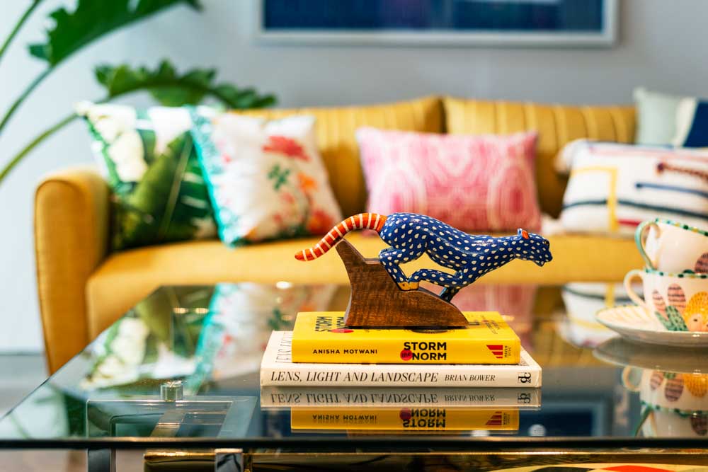 A coffee table with a figurine and books on it