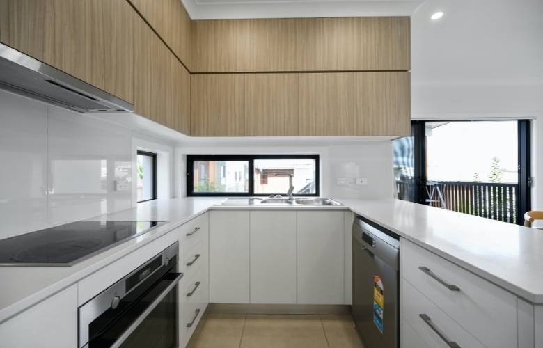 White U shaped modular kitchen with built in kitchen appliances - Beautiful Homes