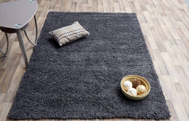 Black area rug on a wooden floor - Beautiful Homes