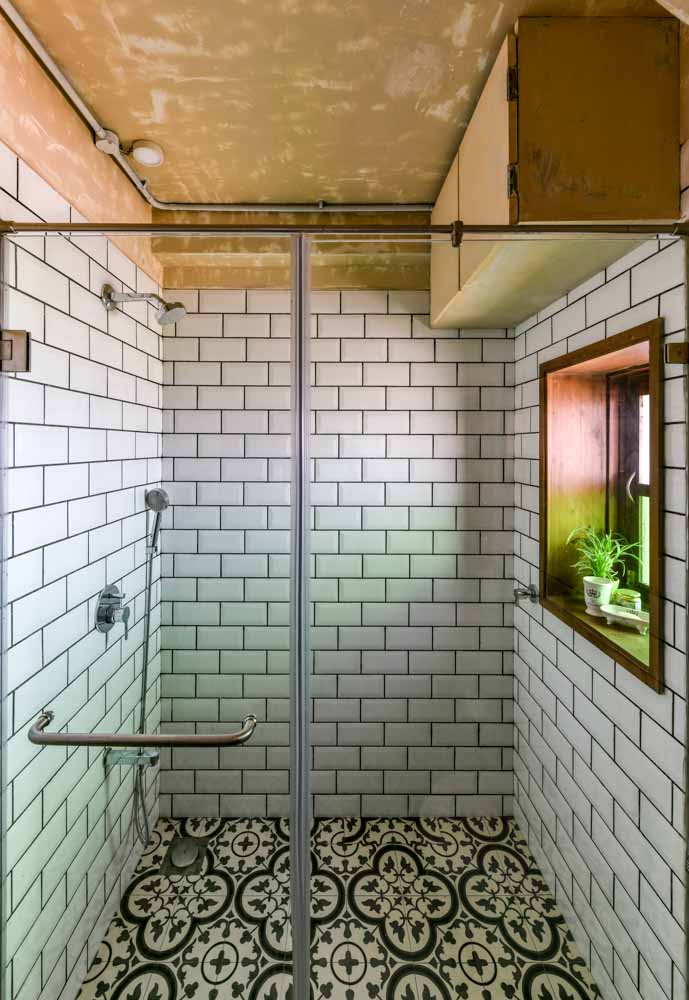 Shower area has patterned tiles on the floor & white bricked tiles on the walls - Beautiful Homes