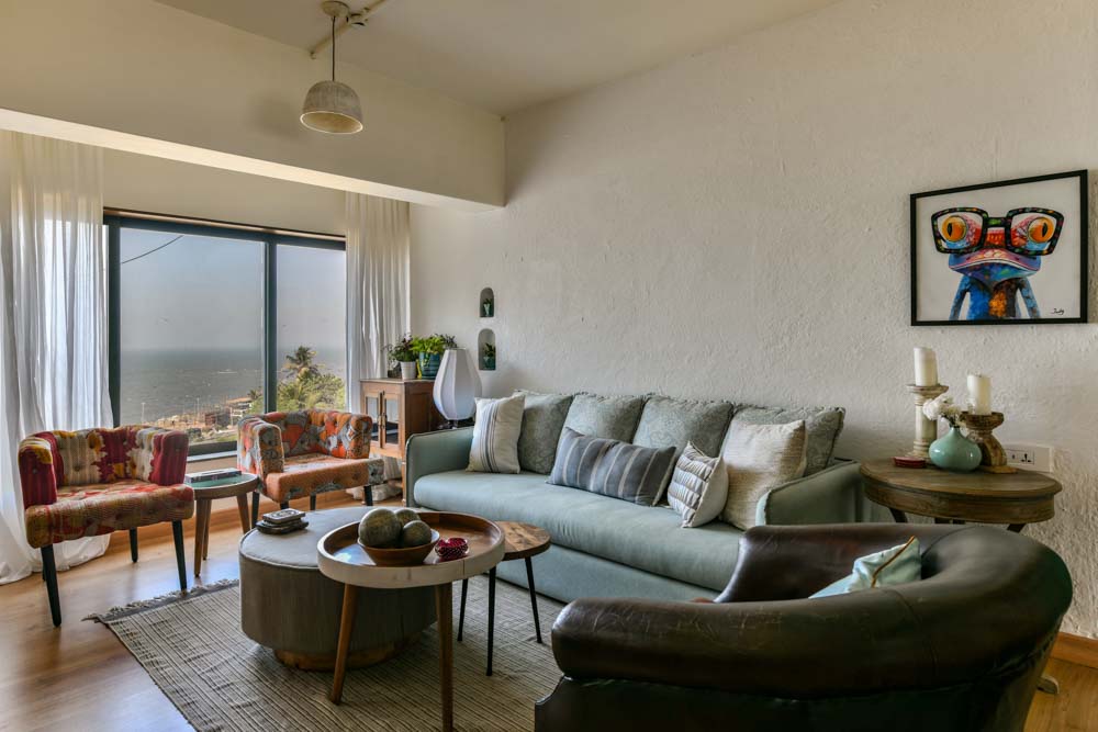 Living room design with patchwork armchairs & sage green sofa for home interior - Beautiful Homes