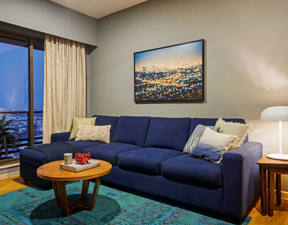 An entertainment room with a large L shaped sofa