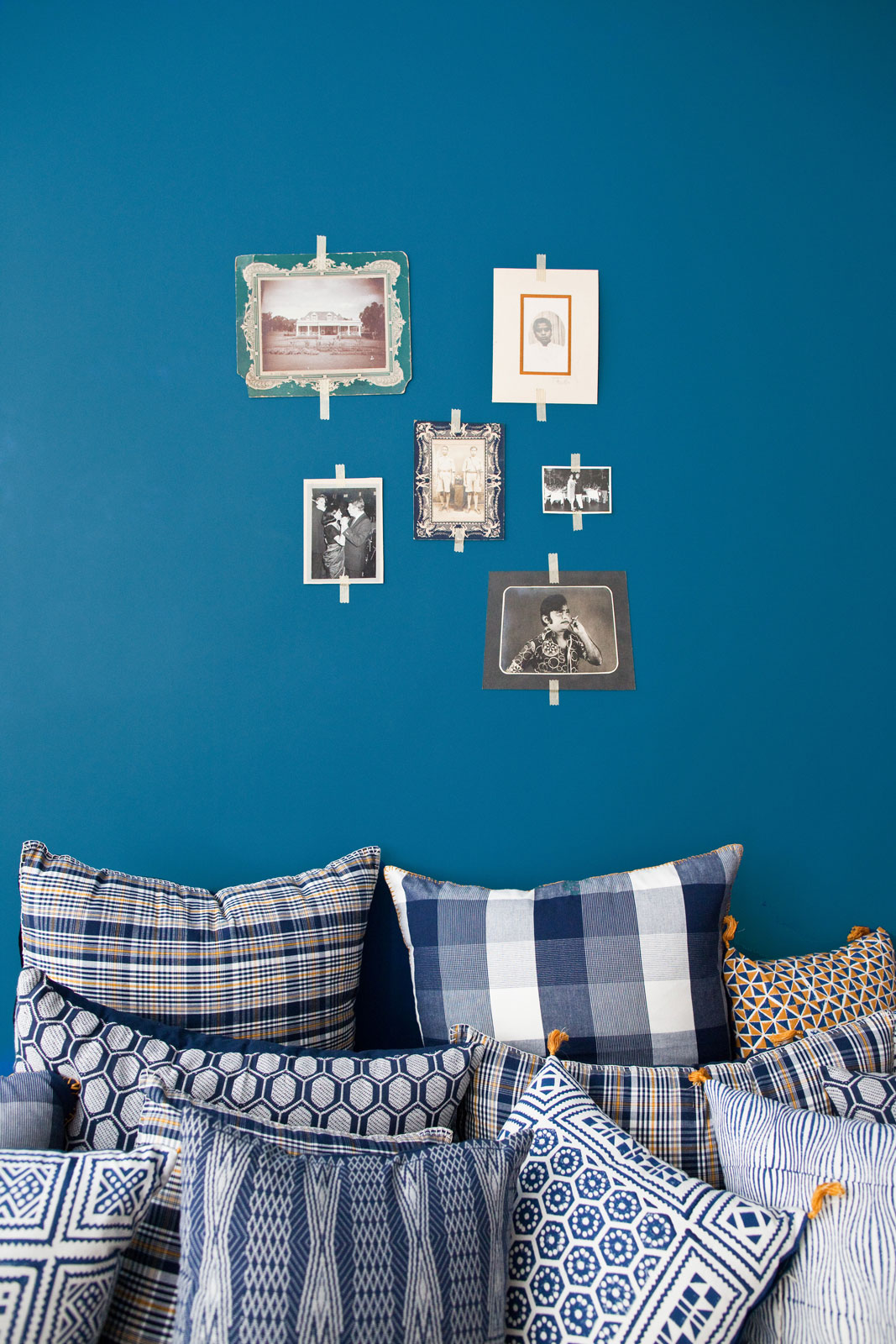 Vintage photographs pasted on the wall with visible tape - Beautiful Homes