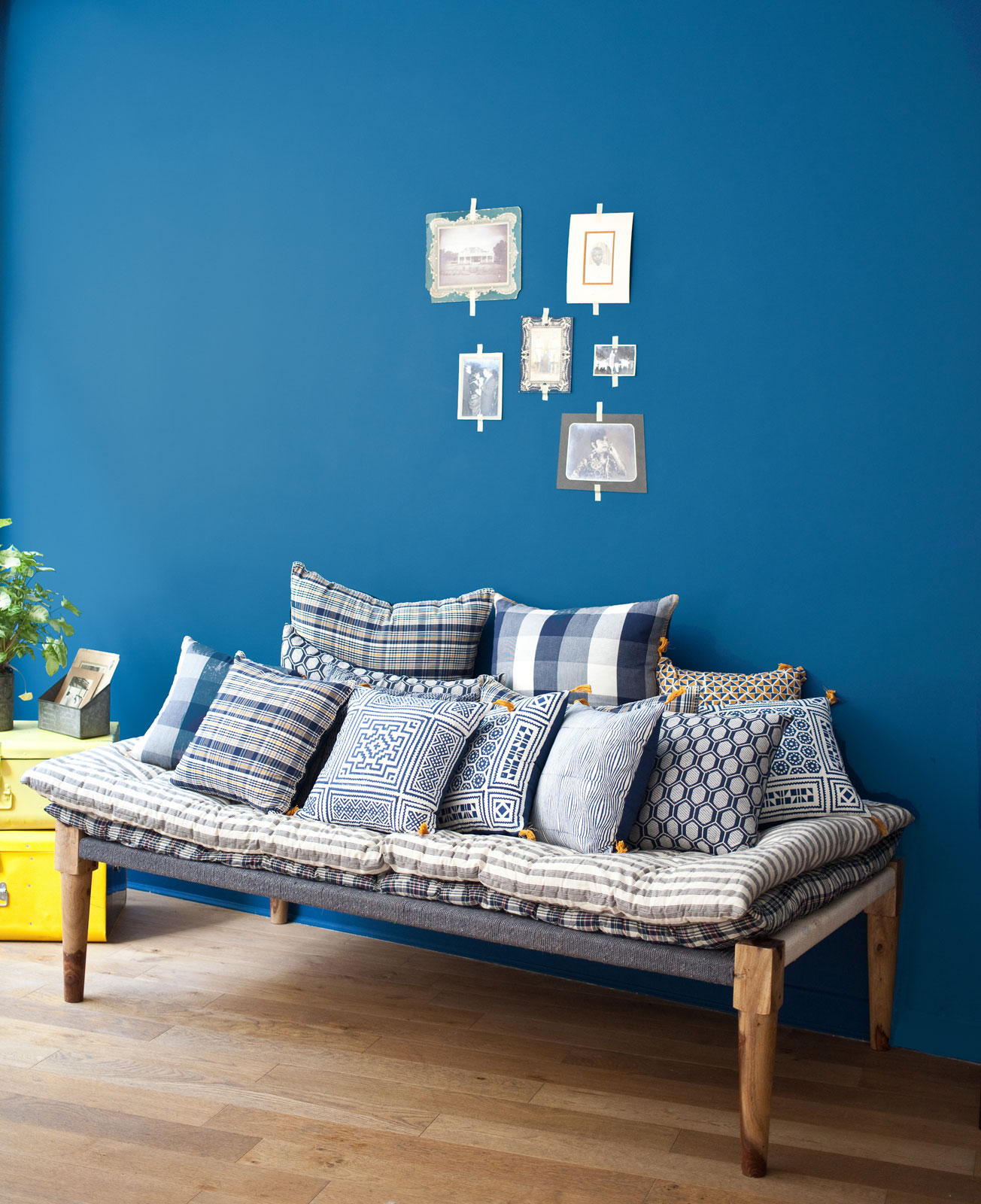 A charpoy styled with a set of cushions at the store's corner - Beautiful Homes