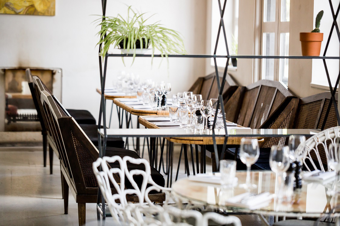 The space is sectioned off by open shelves with wrought iron dominating one section - Beautiful Homes