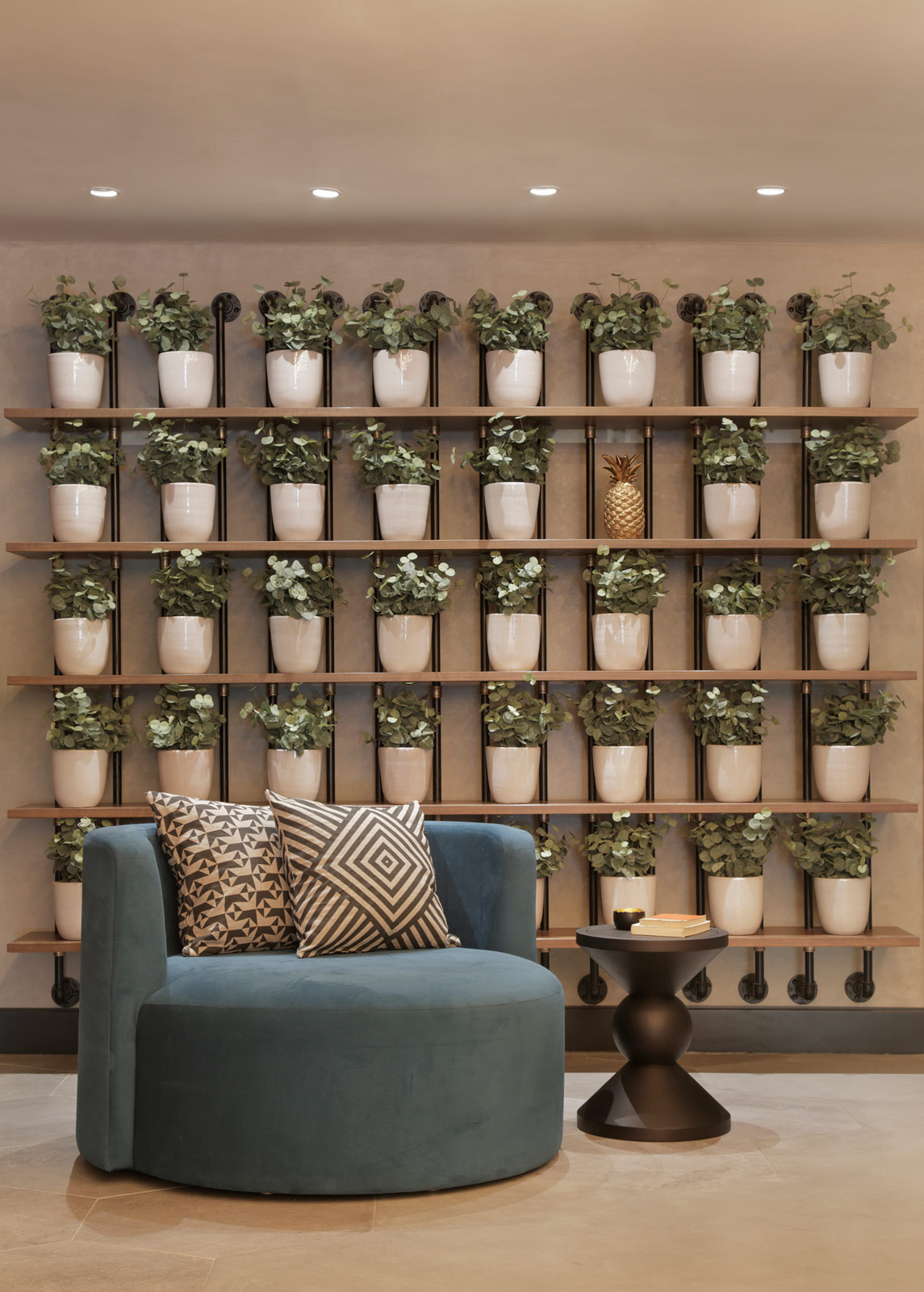 A bare wall in the lobby has been resurrected with a rack full of potted plants - Beautiful Homes