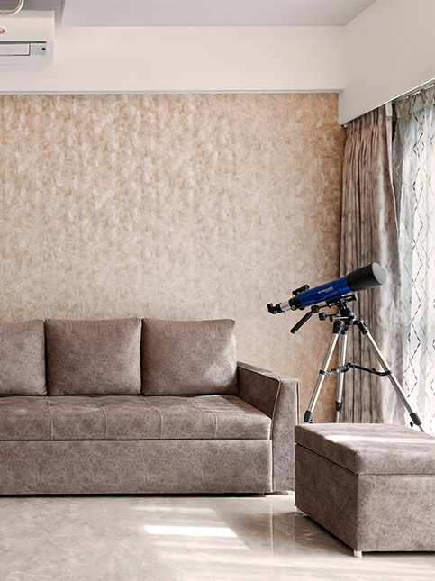 Brown couches in the living room with a matching wallpaper