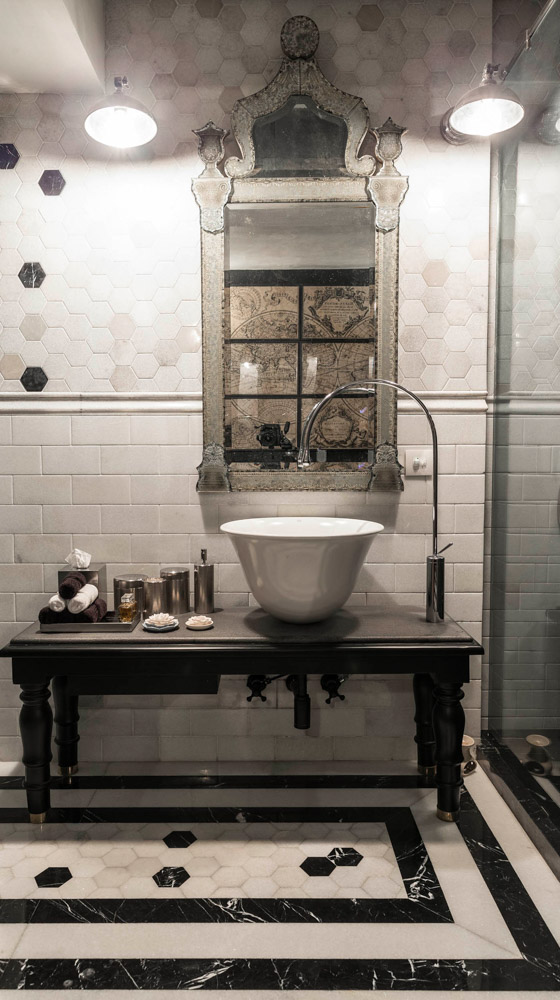 Black-and-white bathroom with silver bathroom accessories and large mirror