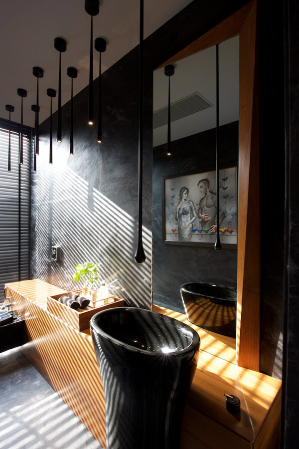 Bathroom lights hanging from the ceiling, deep  grey walls, jet-black sink