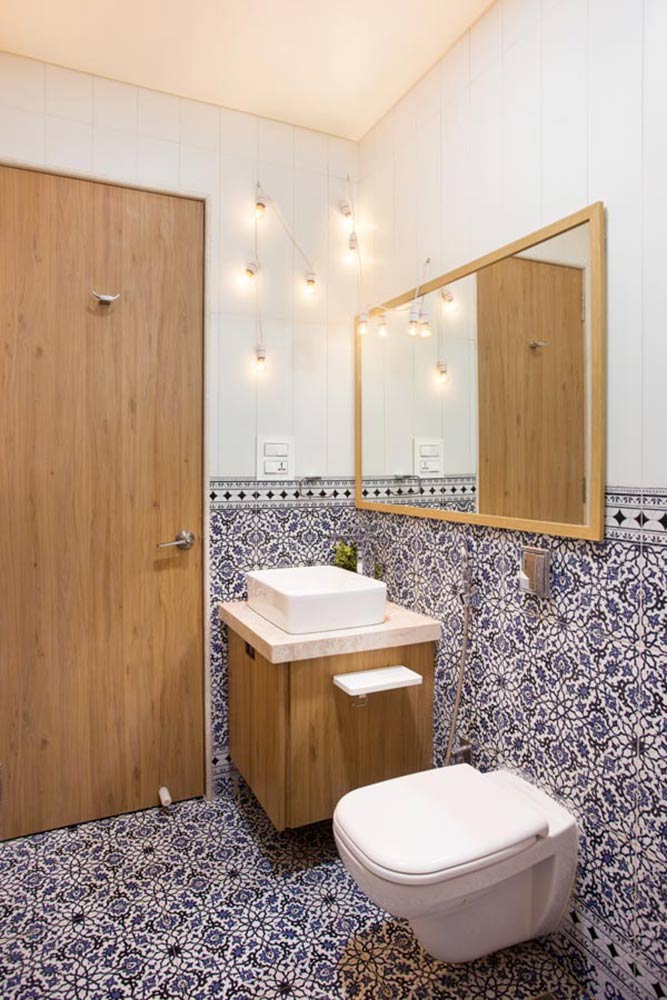 Small washroom design with wood and prints, overside mirror and tiny sink
