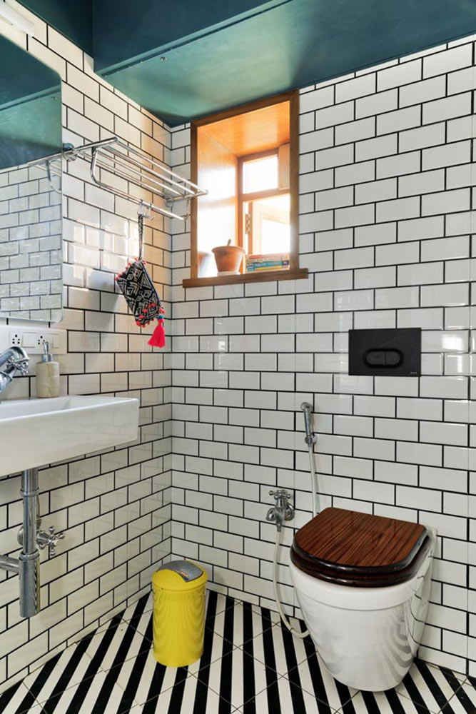 Vibrant and retro small washroom design with striped tiles, tiled walls and green ceiling