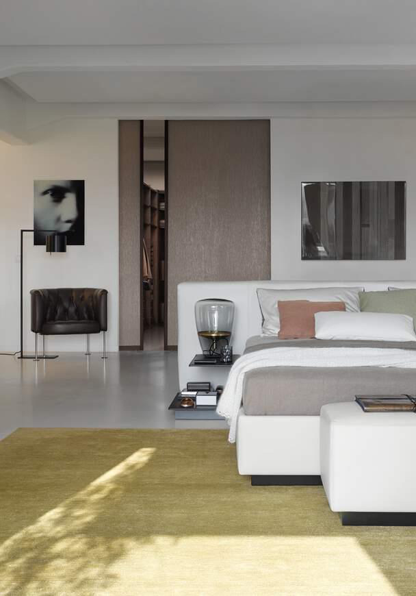 Black floor lamp adding a chic look to this modern bedroom design - Beautiful Homes