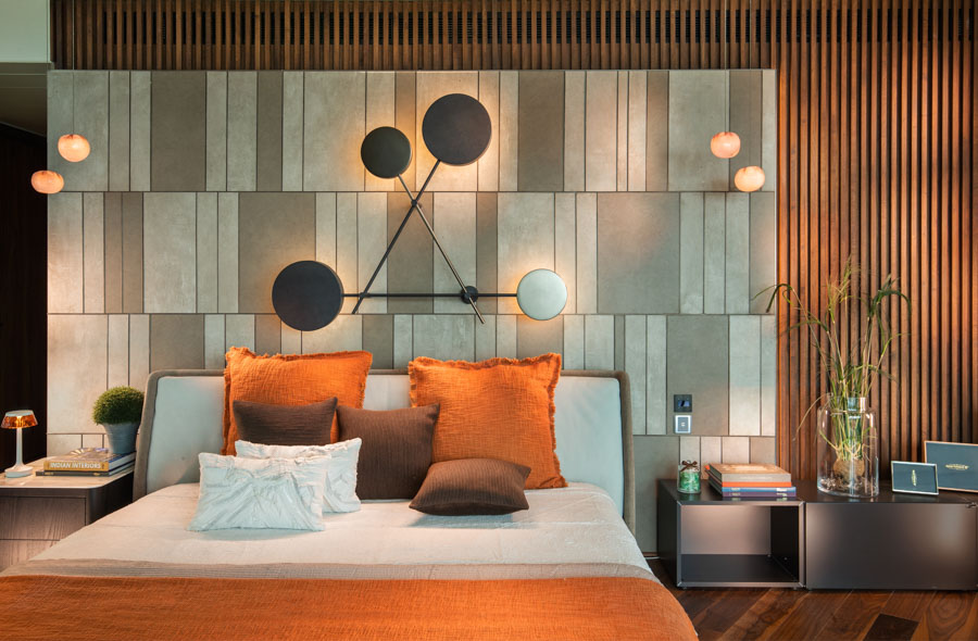 Modern bedroom design with geometric wall elements, many orange shades, black and white details