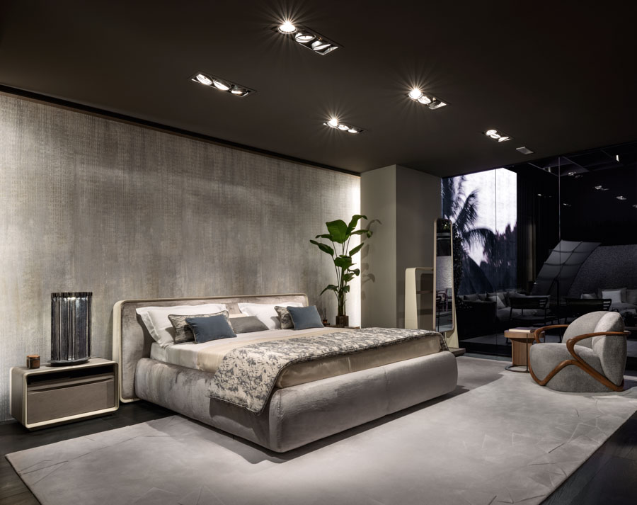 Modern bedroom design with colder shades, velvet bed, big mirrors and a potted plant