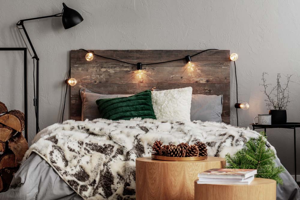 Modern Bedroom décor with wooden headboard & logs for a rustic feel - Beautiful Homes