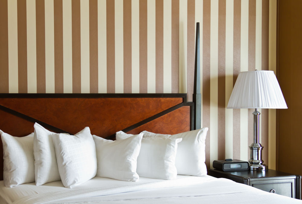 Bedroom striped wall paint design with two contrast shades & elegant wooden furniture - Beautiful Homes 