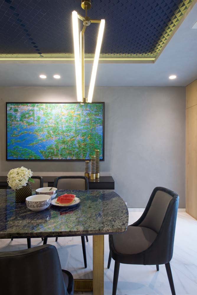 Vibrant dining room décor with granite table top, abstract wall painting & gray chairs - Beautiful Homes