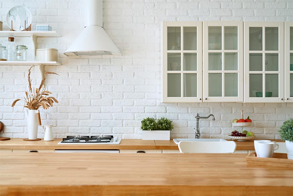 Wooden counter design with brick wall panelling - Beautiful Homes