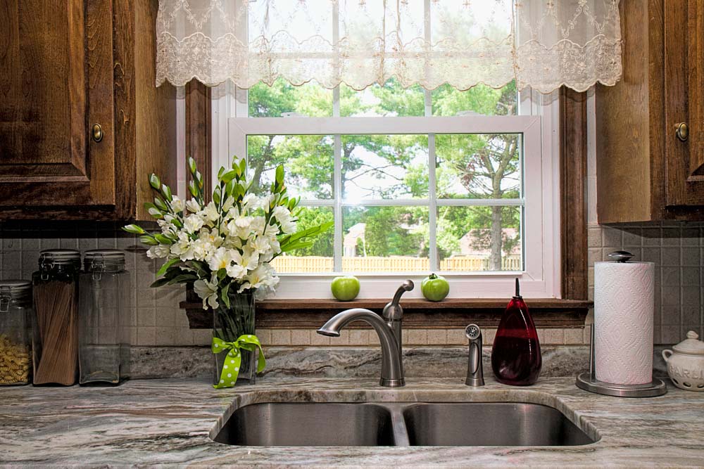 Use embroidered translucent curtains in your kitchen for a vintage vibe kitchen décor style  - Beautiful Homes