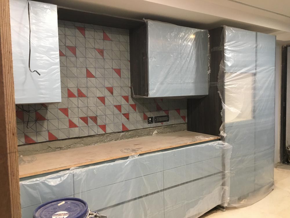 Galley style of the kitchen design with patterned backsplash & modules for storage - Beautiful Homes