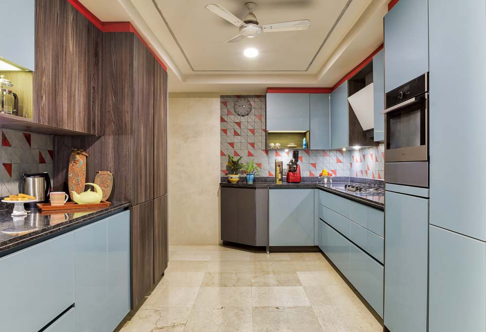 Modular kitchen design with granite kitchen countertop & red triangular backsplash - Beautiful Homes