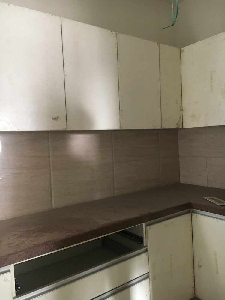 U-shaped kitchen design with dark brown granite kitchen countertop & white kitchen cabinets  - Beautiful Homes