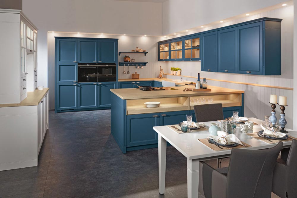 Kitchen interior with yale blue cabinets & light wood butcher countertop - Beautiful Homes