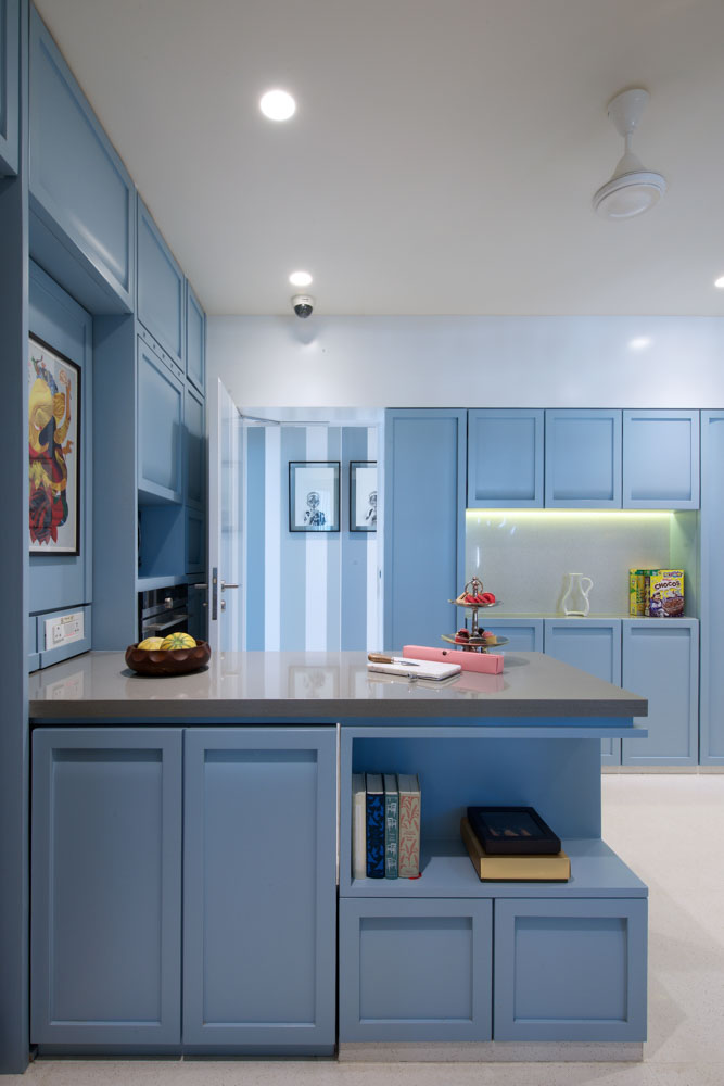 A modular kitchen with solid pastel blue colour complementing overall design - Beautiful Homes