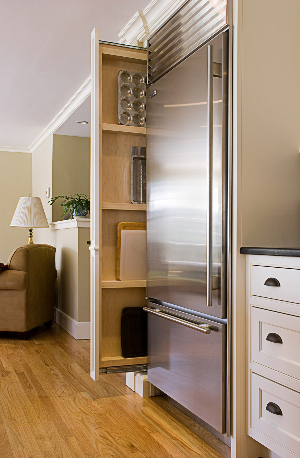 A thin pull out rack can be used to store pantry items in the narrow space between appliances - Beautiful Homes