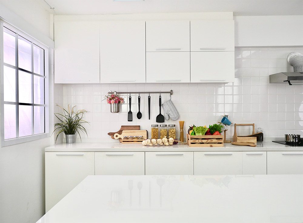 An all white island kitchen design with kitchen accessories - Beautiful Homes